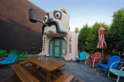 The bulldog building sits on the patio of a restaurant.