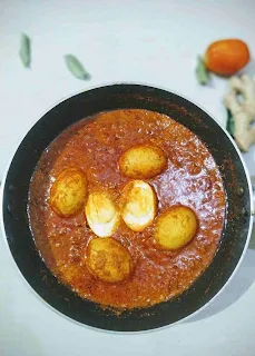 Prepared egg curry recipe with tomato onion gravy in a pan