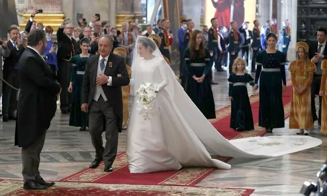 The bride Victoria Romanovna Bettarini wore a white satin gown by fashion designer Reem Acra, and the Lacis Tiara by Chaumet