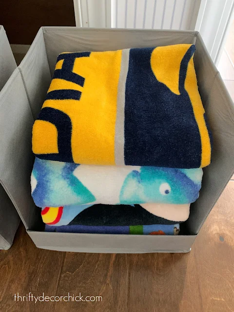 organizing towels in sweater bins