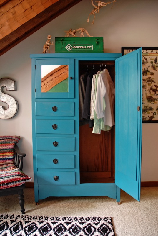 A colorful science and dinosaur themed boy's room in a log cabin home, featuring a built in desk with DIY stainless steel counter top and built in shelves. Paint colors are Cat Eye Green and Ocean Soul Blue.