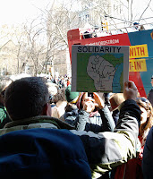 protester with Wisconsin solidarity map sign