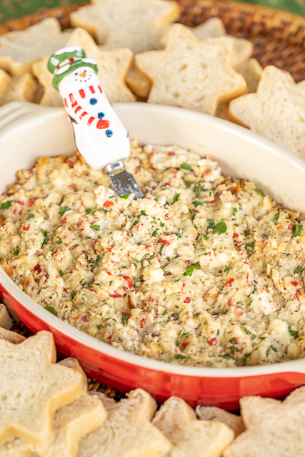 Warm Feta Dip - so simple and tastes great! Perfect for parties and tailgating. Cream cheese, feta, Greek seasoning, garlic, oregano, pimentos, and olive oil. Can make in advance and refrigerate for later. Bake in the oven or in the slow cooker. #feta #cheese #dip #appetizer #partyfood feta dip in baking dish