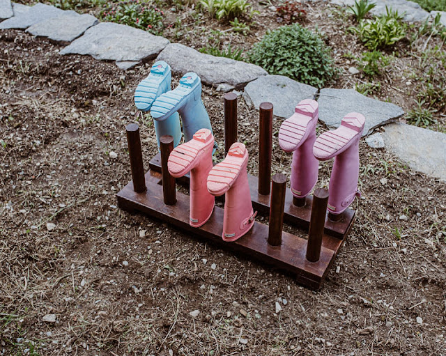 wooden boot stand with colorful boots on it