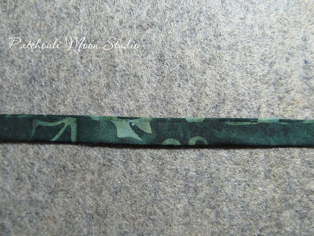 Patchouli Moon Studio~ Fabric Container to Hold Crafter's Edge Die Cuts & Plates fabric strip showing how fabric stems for flowers are made