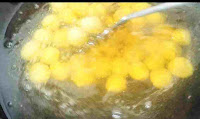 Stirring gulab jamun balls in ghee