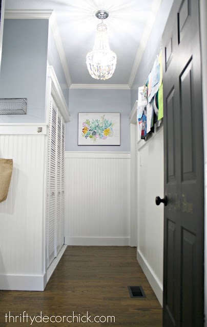 mud room with light blue walls white beadboard