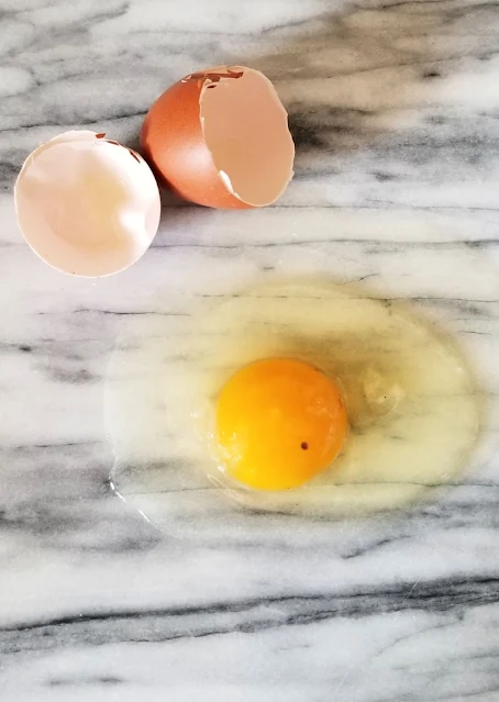 egg cracked on marble countertop