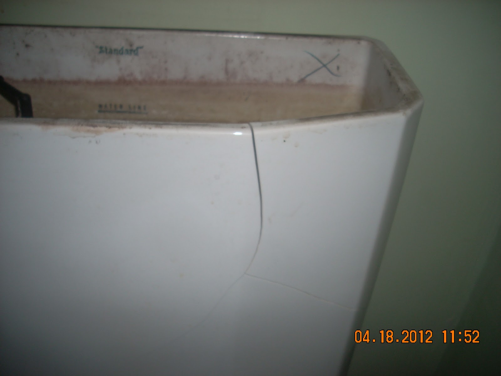 ServiceMaster of Salt Lake Cracked toilet tank causes Flood. Water