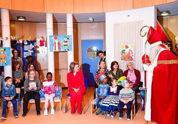 Queen Mathilde visited Queen Fabiola Children's University Hospital. The Queen wore a double breasted orange blazer by Ralph Lauren