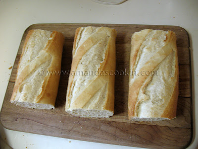 An overhead photo of a French loaf cut into three separate sandwiches.