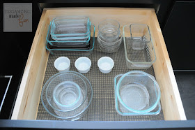 Organized drawer of glass left over containers :: OrganizingMadeFun.com