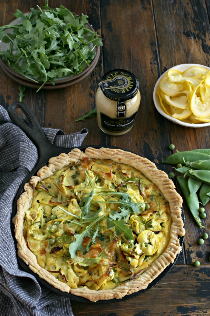 Cheesy savory tart filled with asparagus, peas and yellow squash.