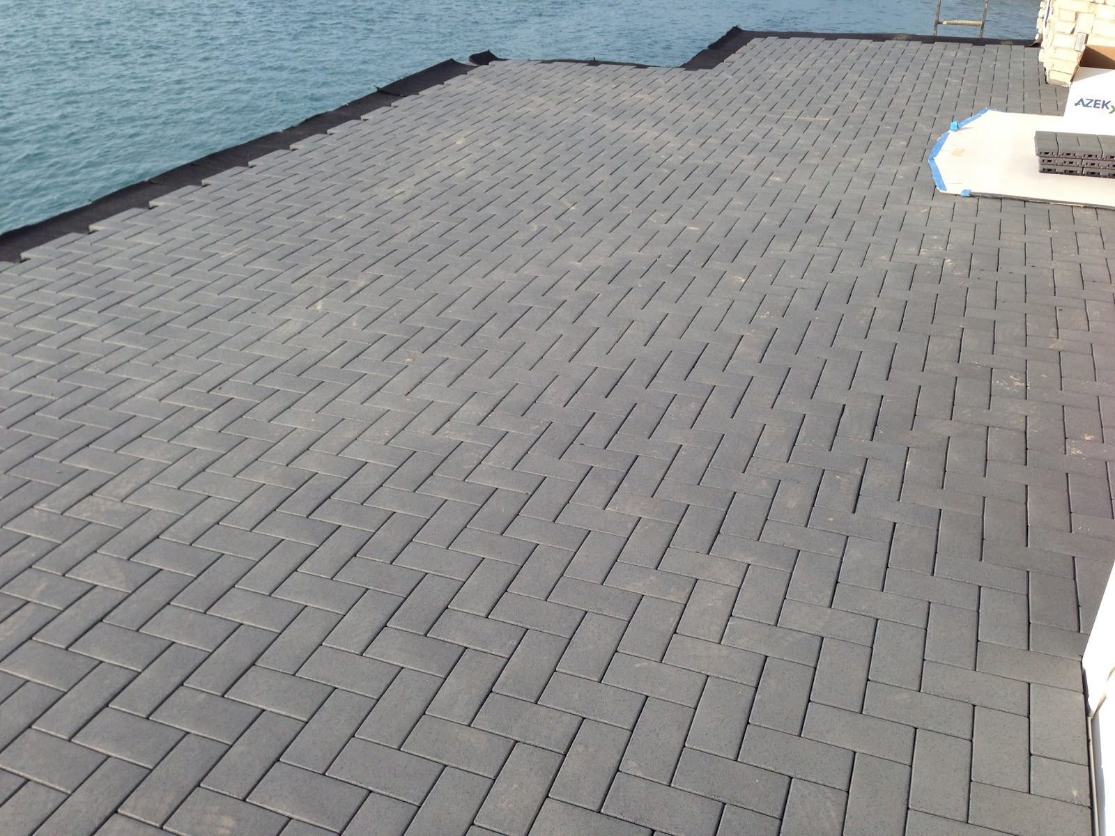 Outdoor Living Low sloped roof decks, composite pavers and cable rail.