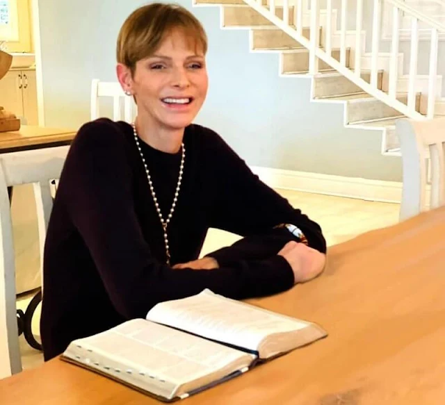 Princess Charlene shared a new photo showing her smiling as she sat at a table in front of an open book