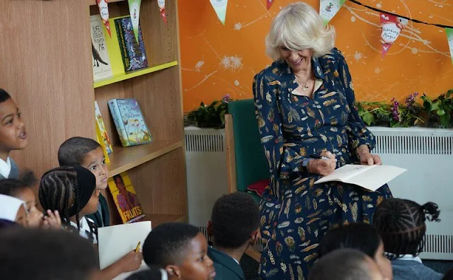 The Duchess of Cornwall wore a navy blue, feather-print dress from Fiona Clare