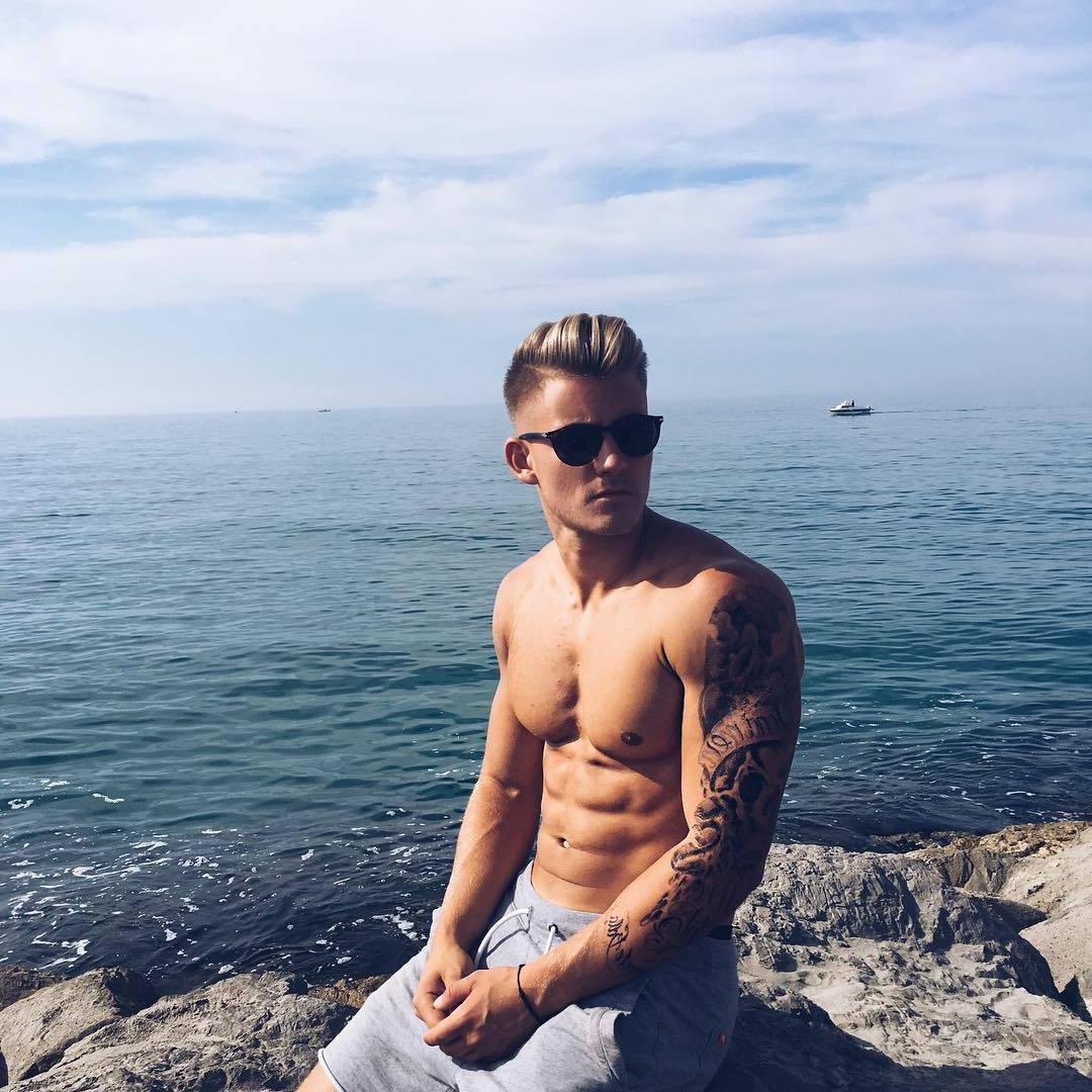 attractive-barechest-dude-with-muscle-pecs-abs-arm-tattoo-sunglasses-ocean