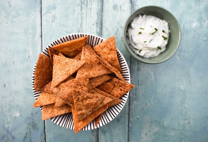 Vegan Paprika Tortilla Chips in a stripy bowl