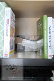 Organized cupboard over fridge for cookbooks and baking supplies :: OrganizingMadeFun.com