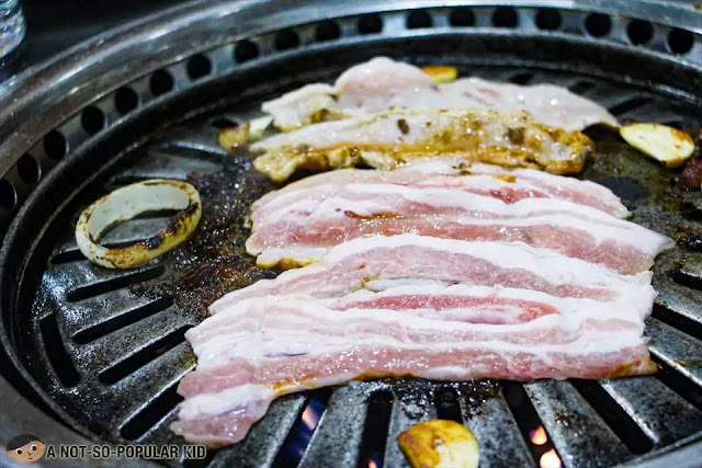 Grilling pork belly aka samgyupsal in Korean Village