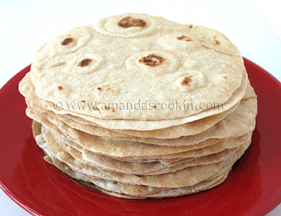 A close up photo of a stack of low fat homemade flour tortillas.