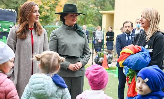 Crown Princess Mary a red contrast-stitch cady dress from Dolce & Gabbana, and double cashmere oslo coat from Joseph