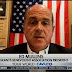 Head of NYPD union gives Fox News interview with QAnon mug in background