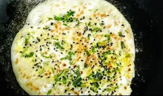 Cooked paneer kulcha topped with kalonji and chopped coriander leaves