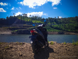 Motorcycle Parked By The Lake Water Dam With Beautiful Hills Scenery On A Sunny Day Titab Ularan North Bali Indonesia