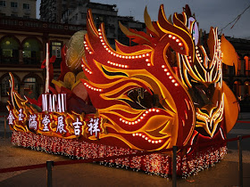 Lunar New Year rooster parade float lit up at night in Macau
