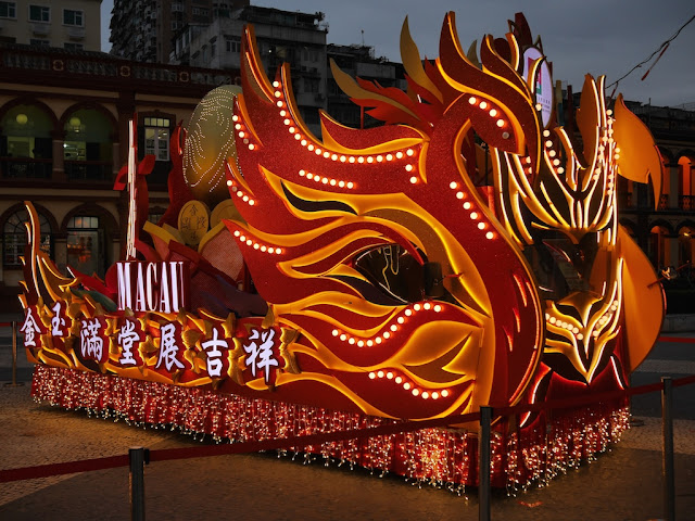 Lunar New Year rooster parade float lit up at night in Macau