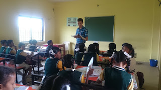Teaching an English lesson at the school to a class of 7 year olds