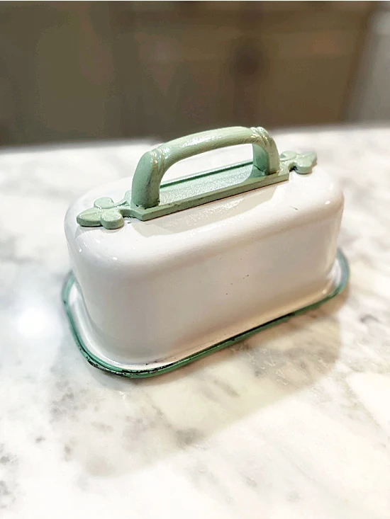 green handled butter dish from enamelware container