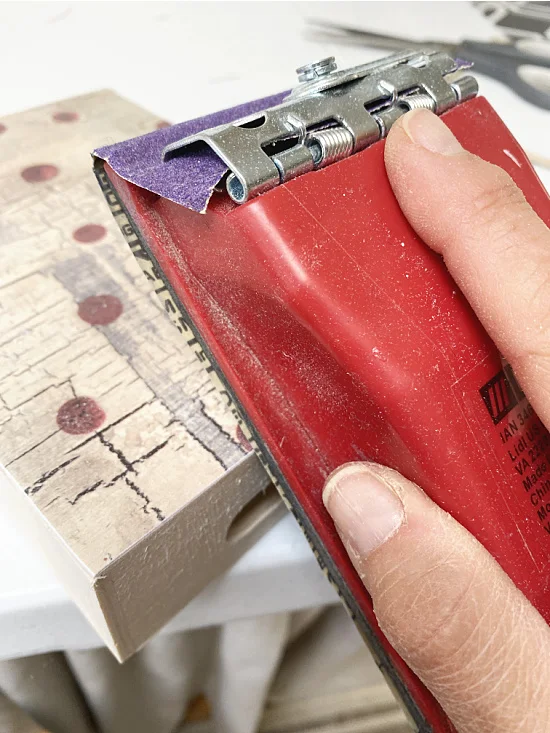 sanding the box using a block sander