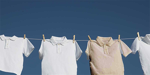 Why do white clothes become dull in after repeated washing?