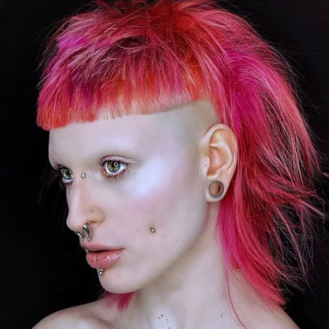 selfie of a young woman with short mullet haircut and buzzed sides