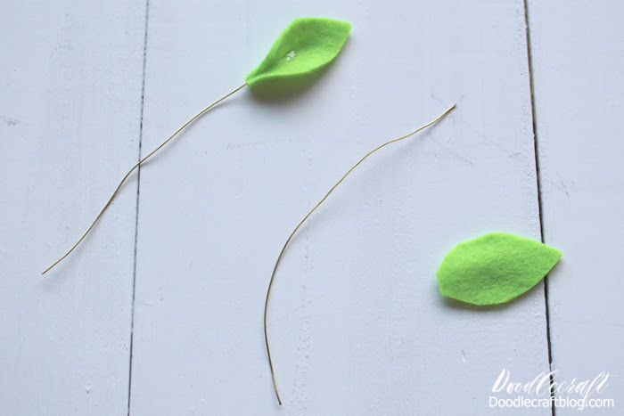 Step 5: How to Make Felt Leaves To make the flower spray a little more dimensional, clip some floral wire about 4 inches long.  Hot glue a green leaf shape on each end, pinching it around the wire in the center.
