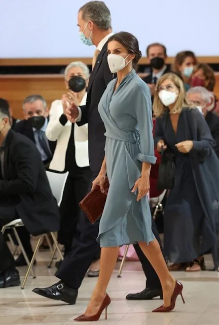 Queen Letizia wore a new wrap around dress by Adolfo Dominguez. Red pumps by Magrit. Earrings by Tous jewelry