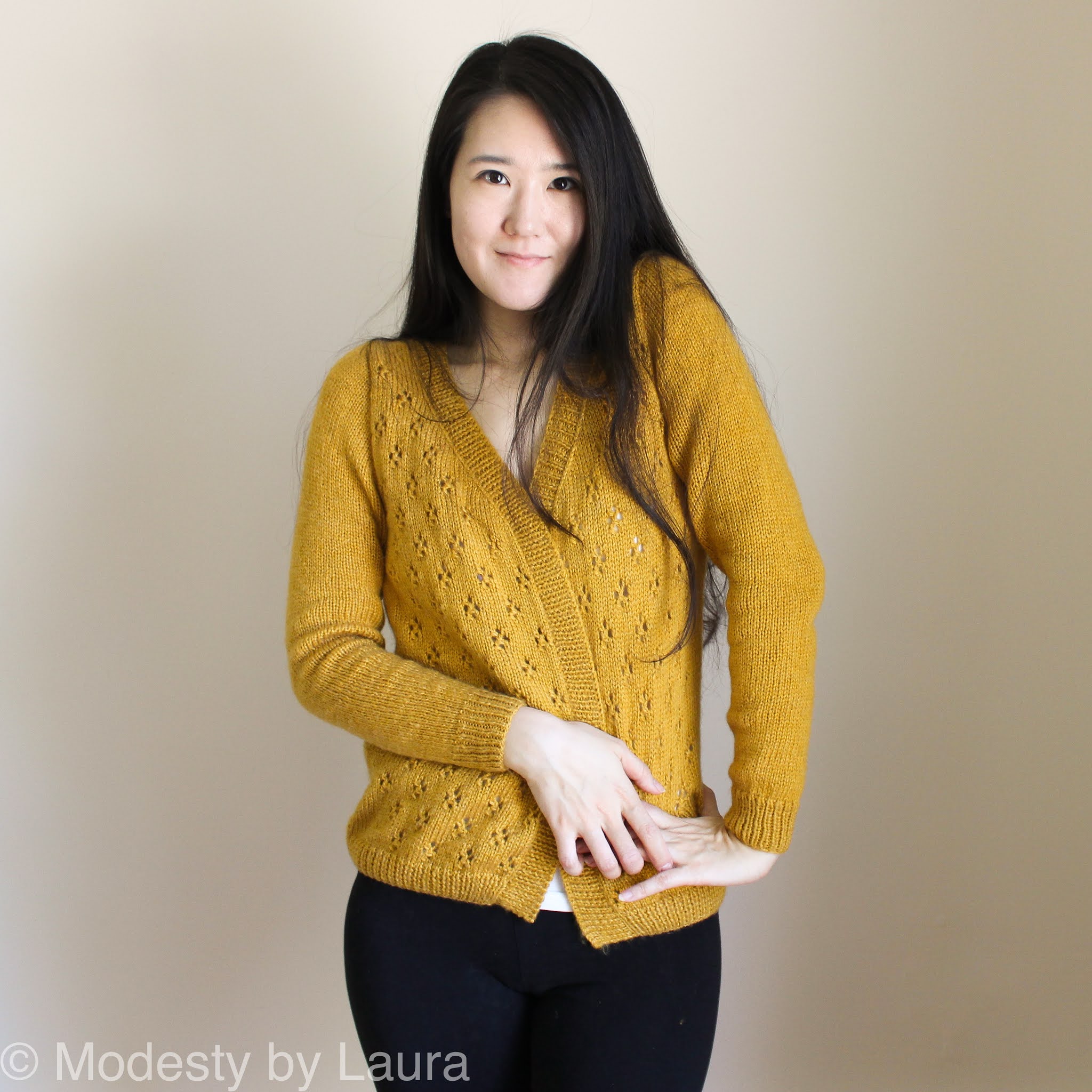 Korean American Designer wearing knit Cheese in the Trap Cardi. Designer for Modesty by Laura.