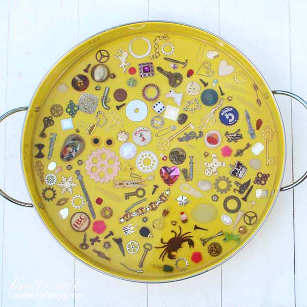 This I spy game resin serving tray filled with miniatures and trinkets is a fun DIY and would make a great gift! Fill the tray with little things from the junk drawer or little heirlooms that sit in a jewelry box collecting dust. With a thick layer of glossy resin, the trinkets stay in place and offer a smooth surface for using the tray for serving or a coffee table catch all. 