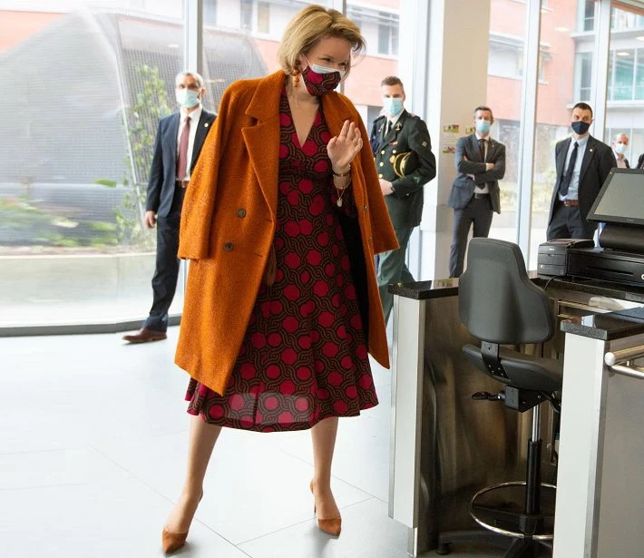 Queen Mathilde wore a new faux wrap cotton dress from Dries Van Noten, and a wool cahmere coat from Natan, and Natan pumps