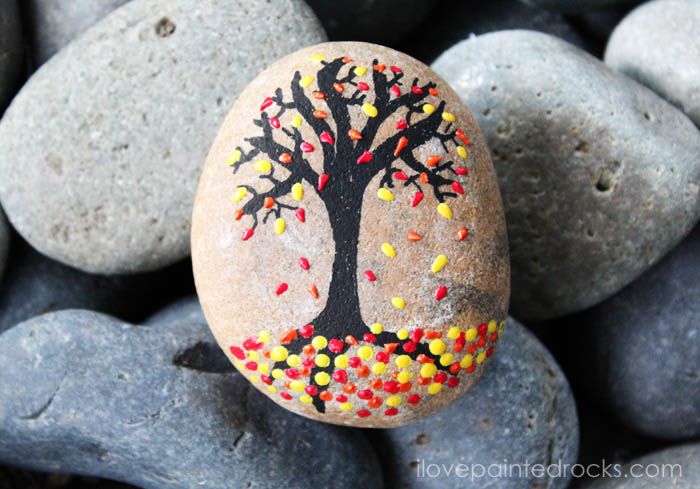 What a cool fall rock painting idea. Using 3D paint makes it easy to make the leaves on this beautiful tree painted rock. #ilovepaintedrocks #rockpainting #PaintedRockIdeas #paintedrocks #paintrock #kindnessrocks #paintedstone #rockart #stoneart #paintedstoneideas #crafts #rockcrafts #fall #fallcraft #fallpainting