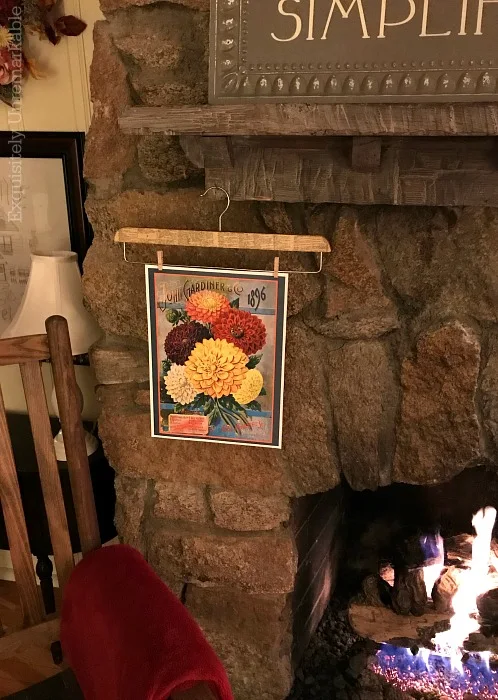 Rustic Living Room Stone Fireplace with seed packet artwork hanging on it