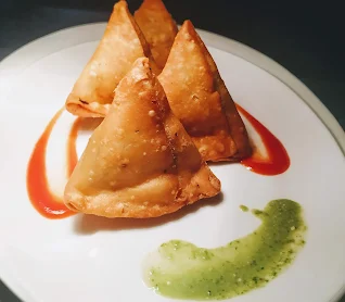 Serving samosa with mint Chutney and tomato ketchup for Samosa recipe