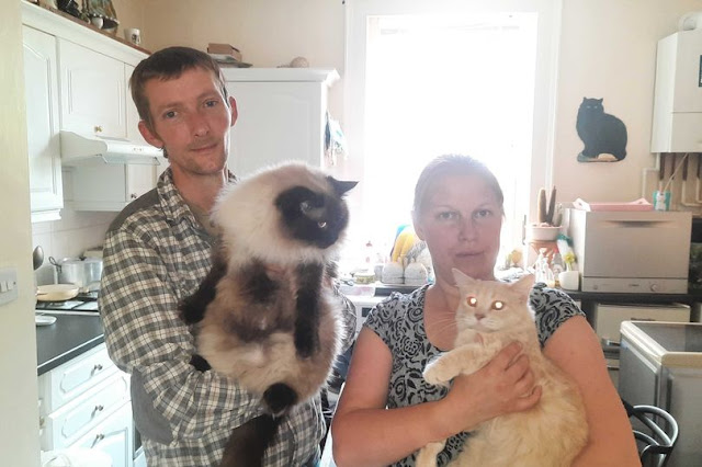 Simon and Joanne Graham with two of their 3 cats one of which appears to be a Ragdoll