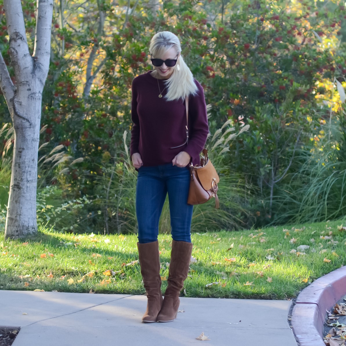 sweater jeans and boots outfit