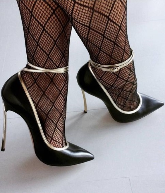 Black pumps wiith ankle traps and black fishnet tights