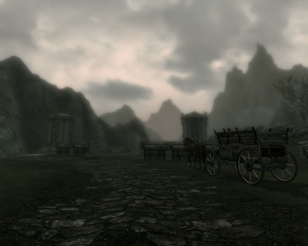 paved road goes past a horse-drawn cart and bends left, a little foggy, many dark clouds in the sky