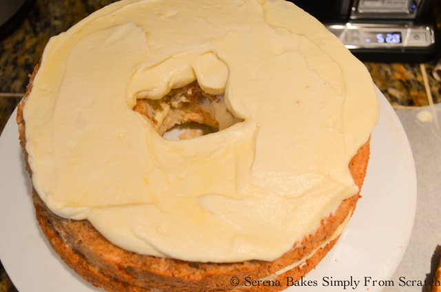 Cover coffee infused cake with mascarpone cheese mixture for Tiramisu Cake.