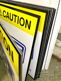 A collection of caution signs on metal material.